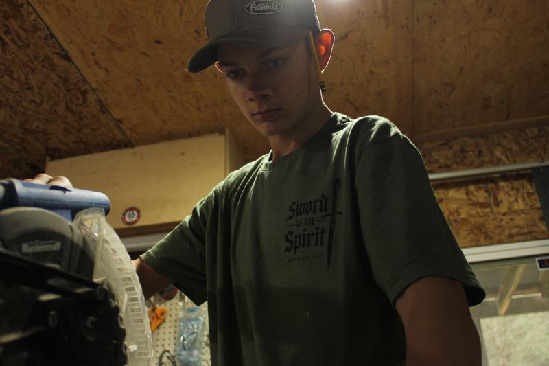Working in the shop in the Sword of the Spirit tee